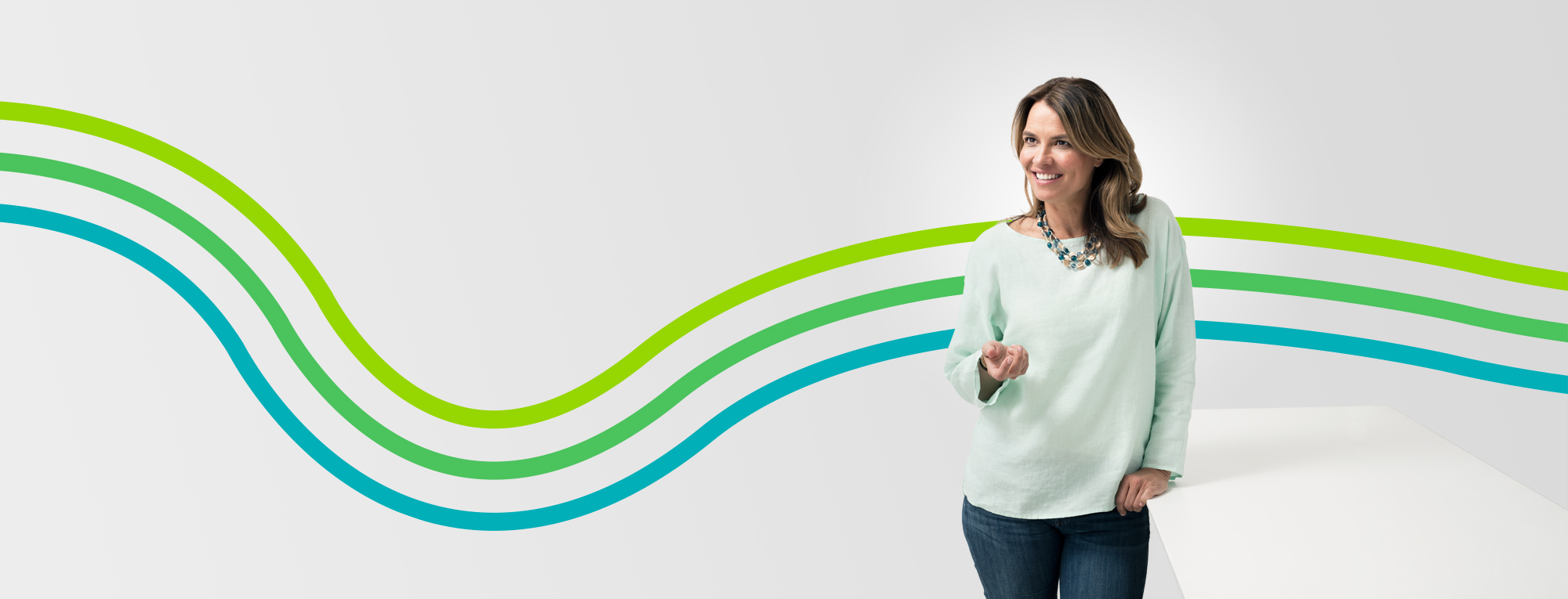 Smiling, standing middle-aged woman featured in an article about staying fit for less